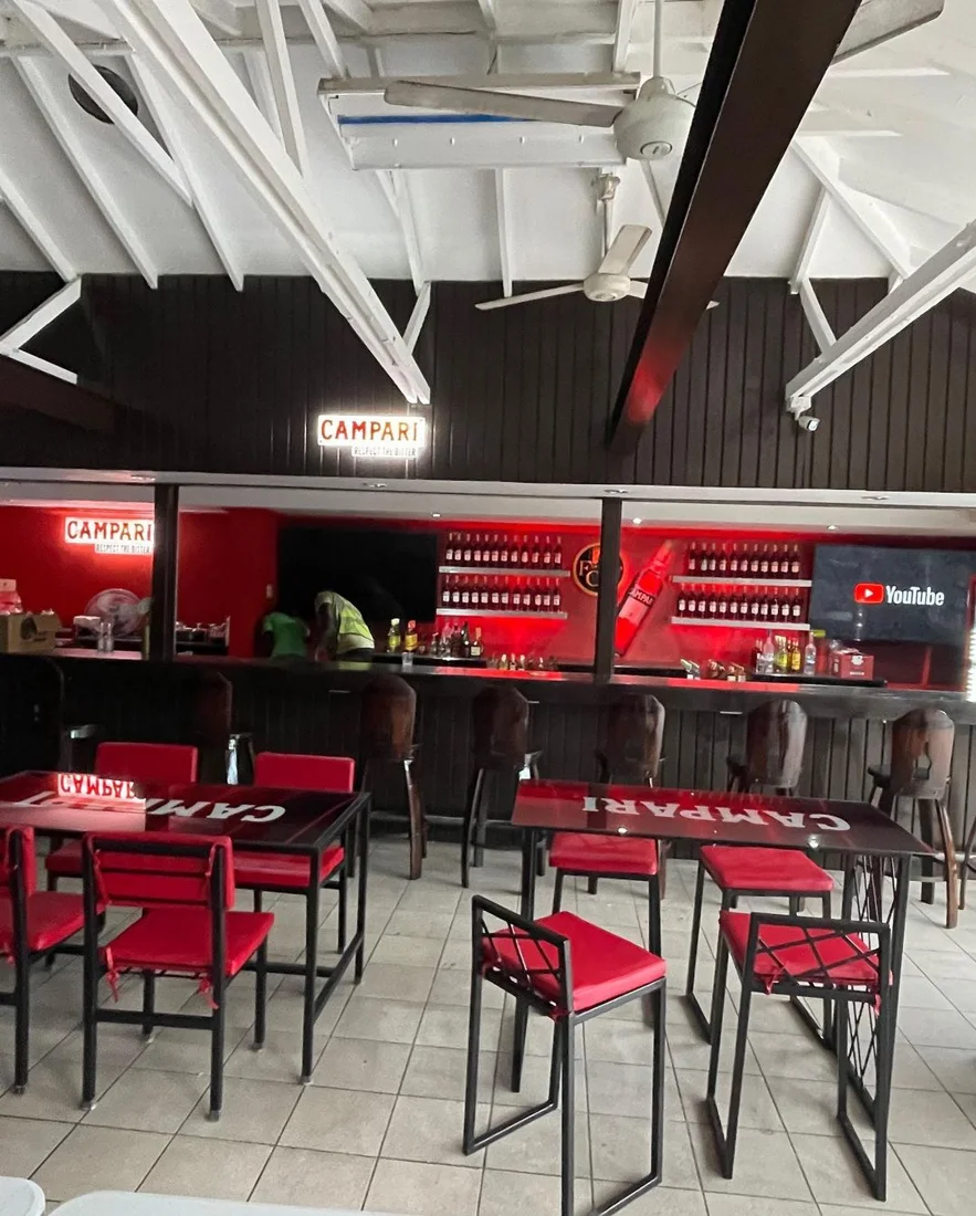Bar interior with red stools and branded counters