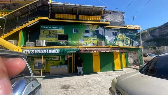 Wide view of a green and yellow bar exterior