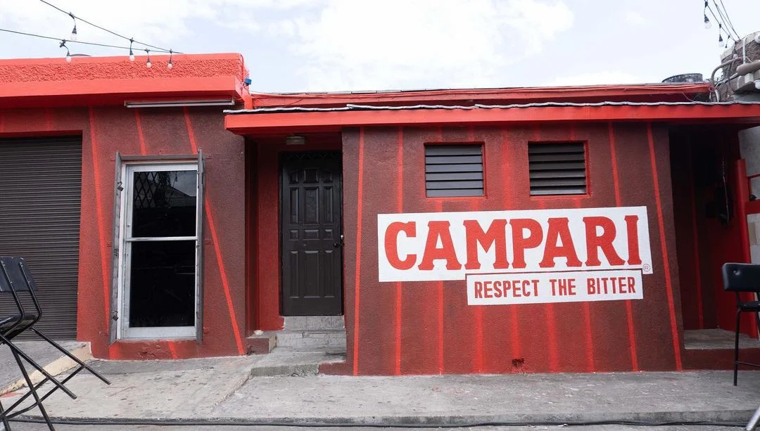 exterior of a bar with a red branded facade